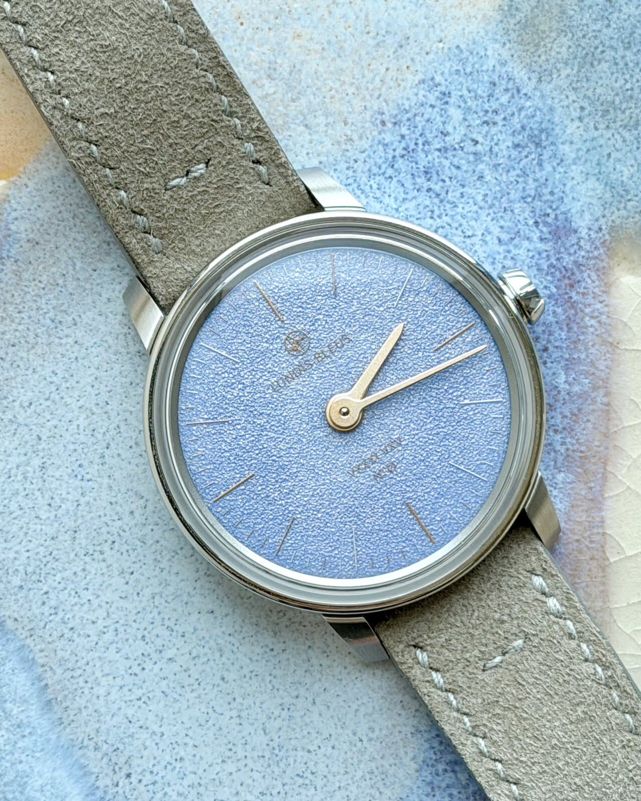 The custom Lundis Bleus enamel watch on the wrist